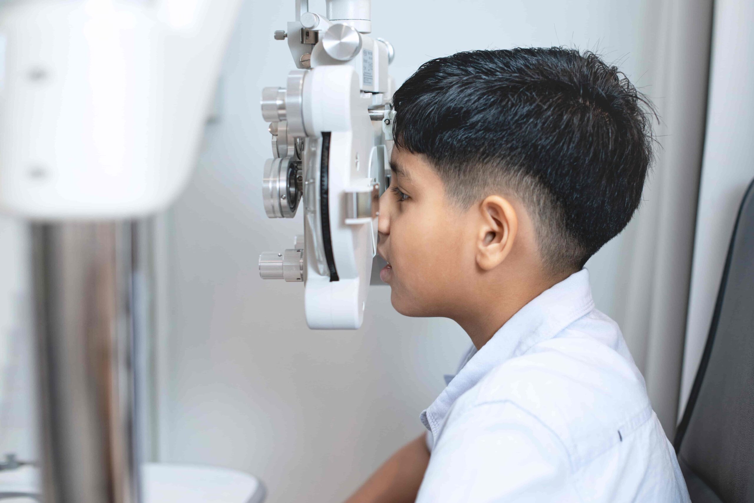 Boy undergoing eye visual screening